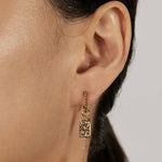 Beaded Huggie Earrings with stacked charms closed-up view