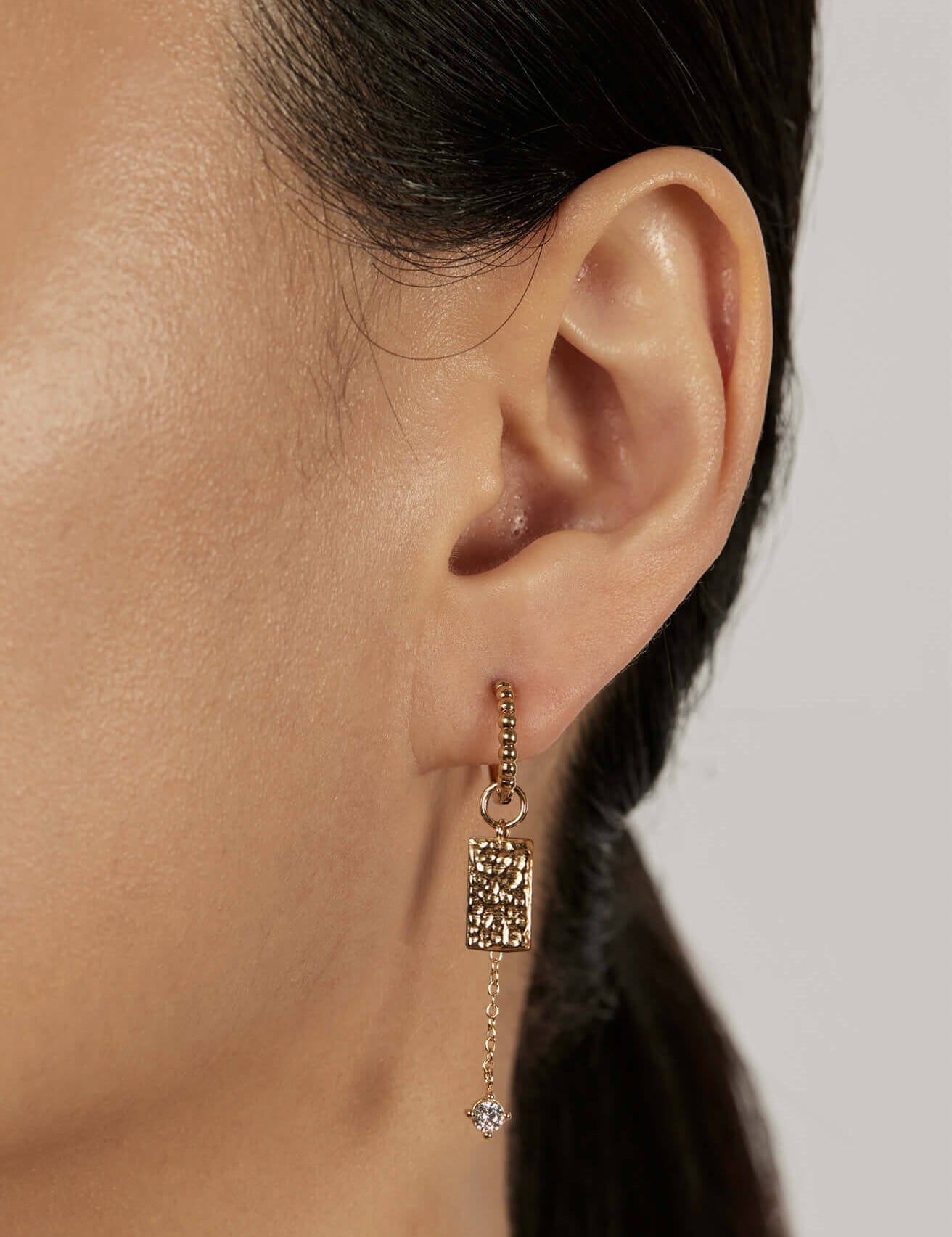 Beaded Huggie Earrings with stacked charms closed-up view