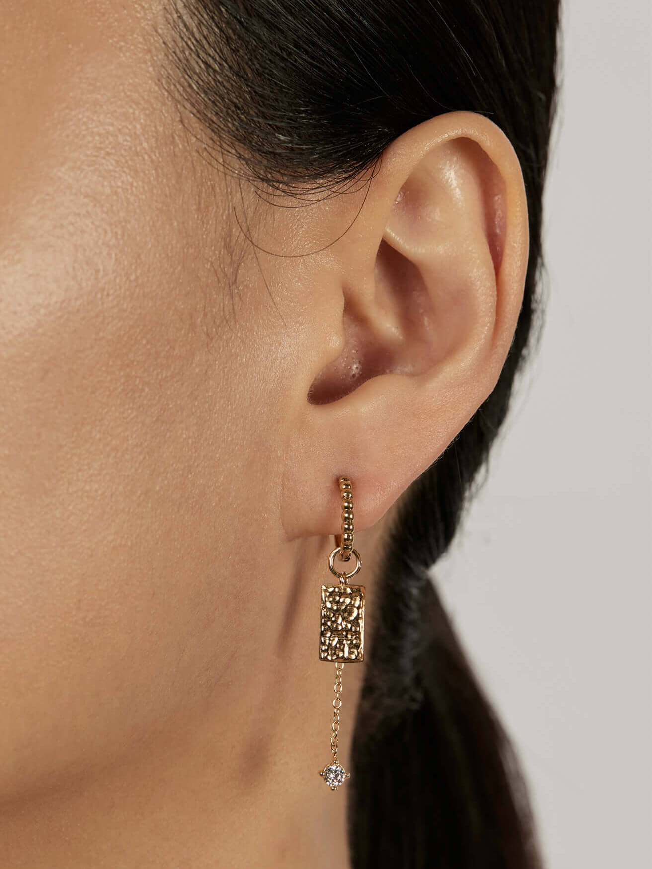 Beaded Huggie Earrings with stacked charms closed-up view