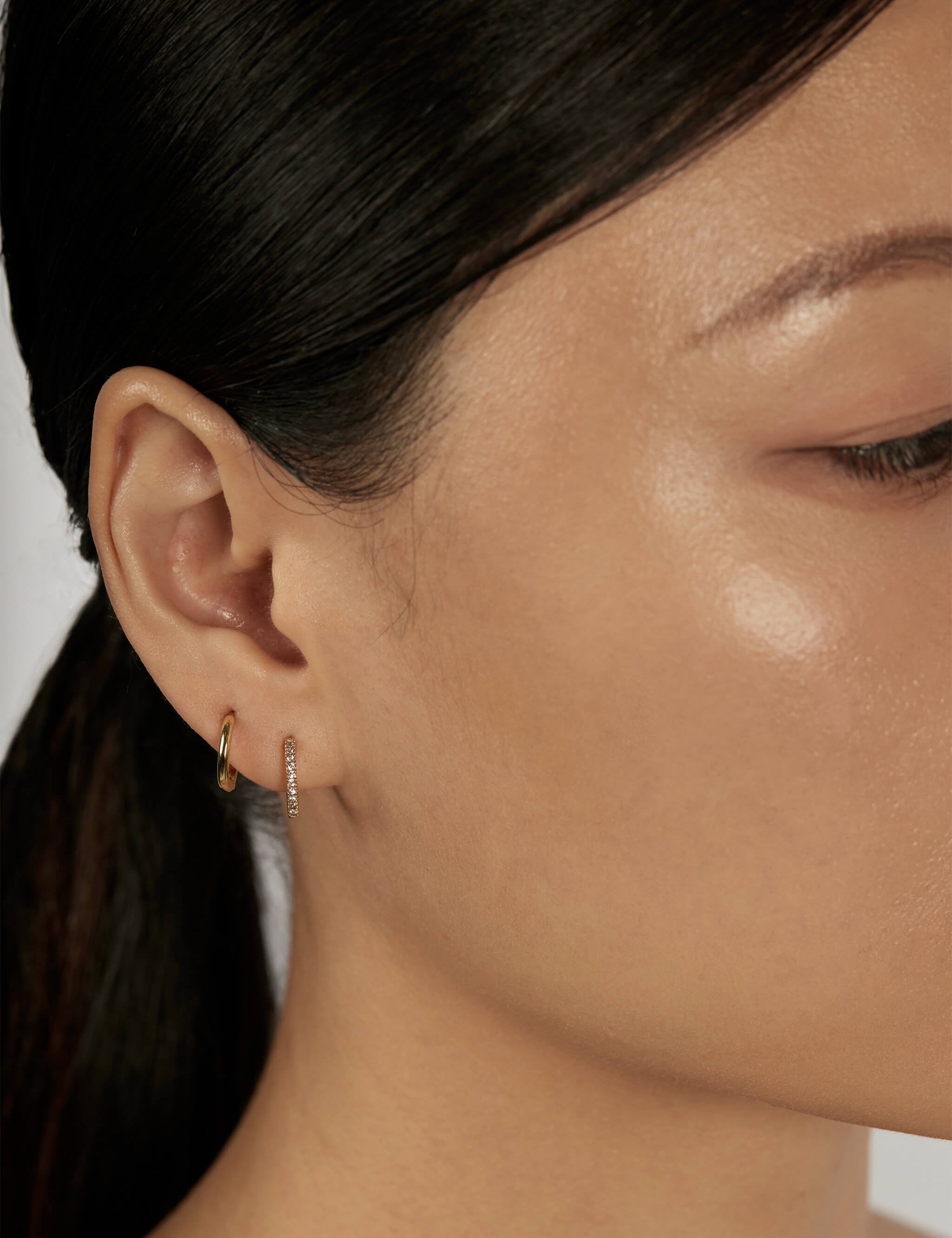 Classic and Pave Huggie Earrings styled for stacked piercings