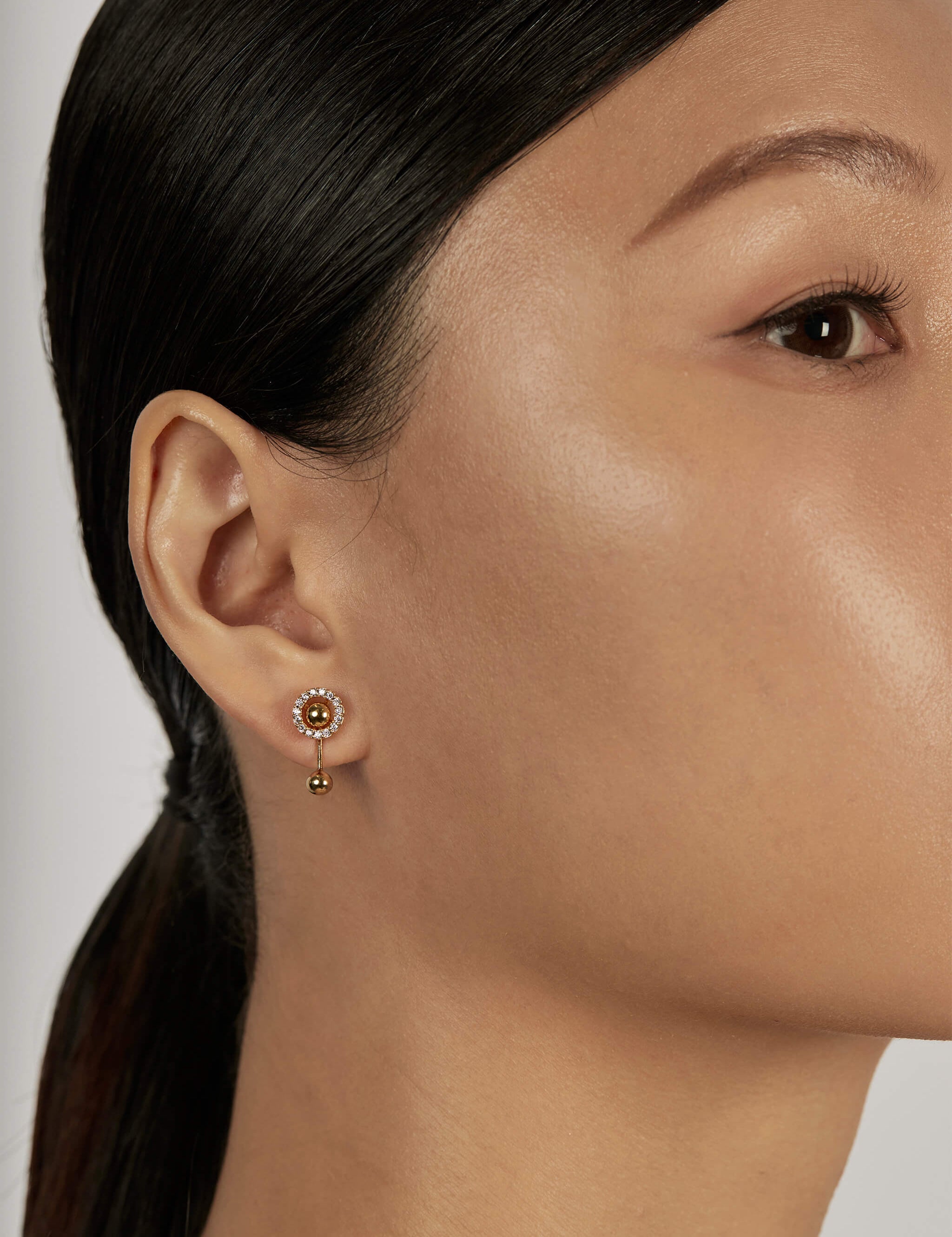 Halo Ear Jacket Earrings styled with gold sphere
