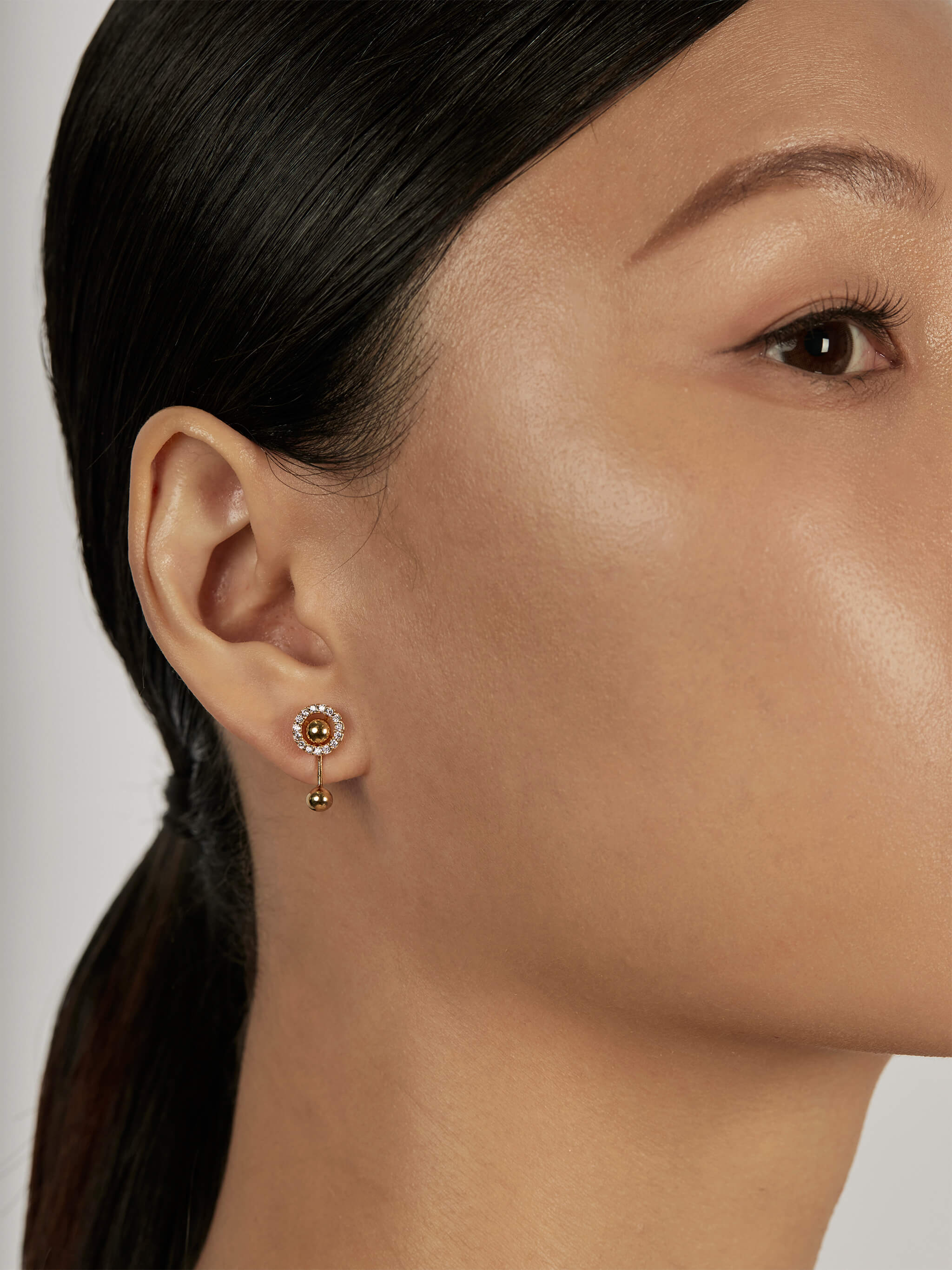 Halo Ear Jacket Earrings styled with gold sphere