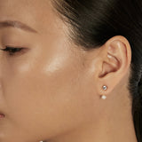 Solitaire Stud Earrings styled in a minimal ear stack