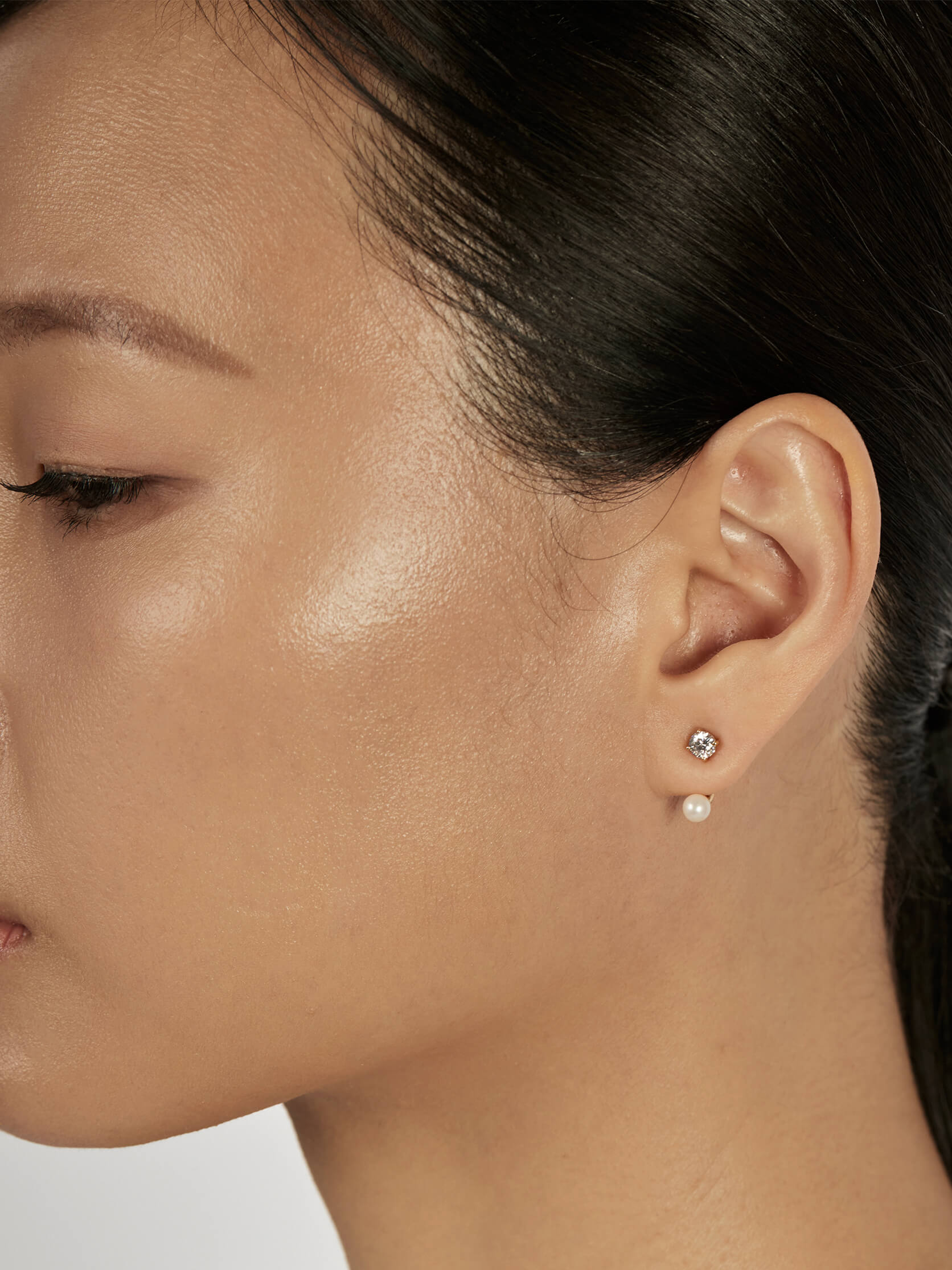 Solitaire Stud Earrings styled in a minimal ear stack