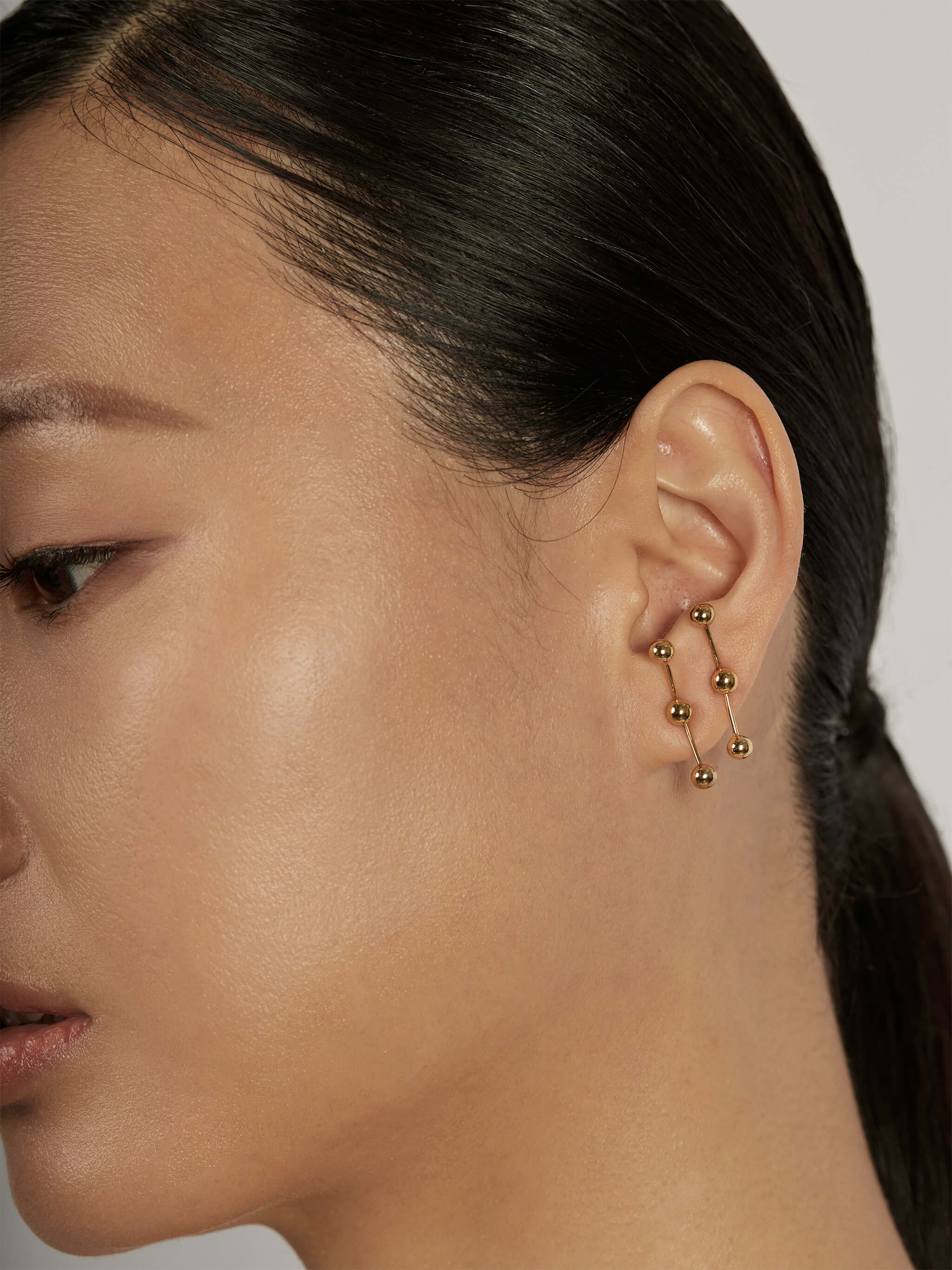 Sphere Drop Ear Jacket Earrings styled in double vertical for stacked piercings