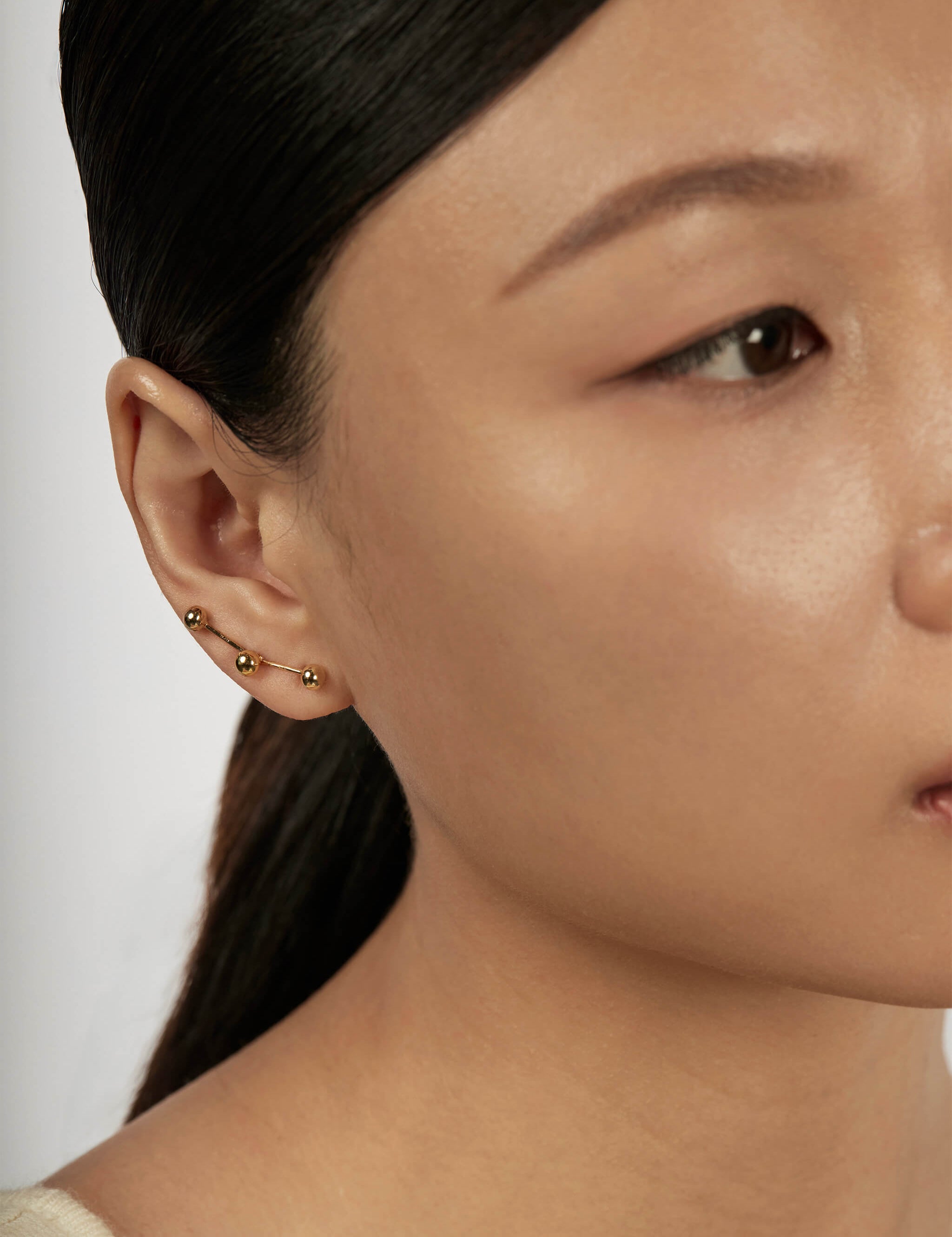 Sphere Drop Ear Jacket Earrings styled in a layered ear stack
