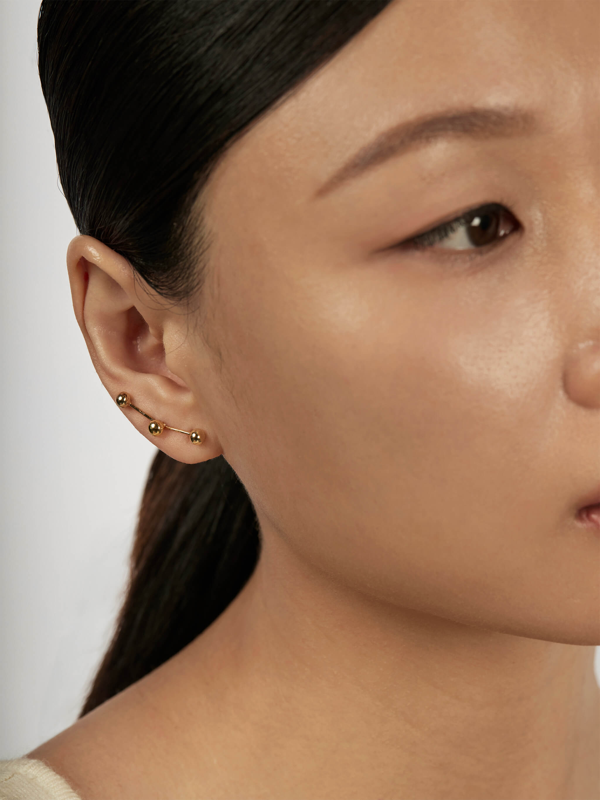 Sphere Drop Ear Jacket Earrings styled in a layered ear stack
