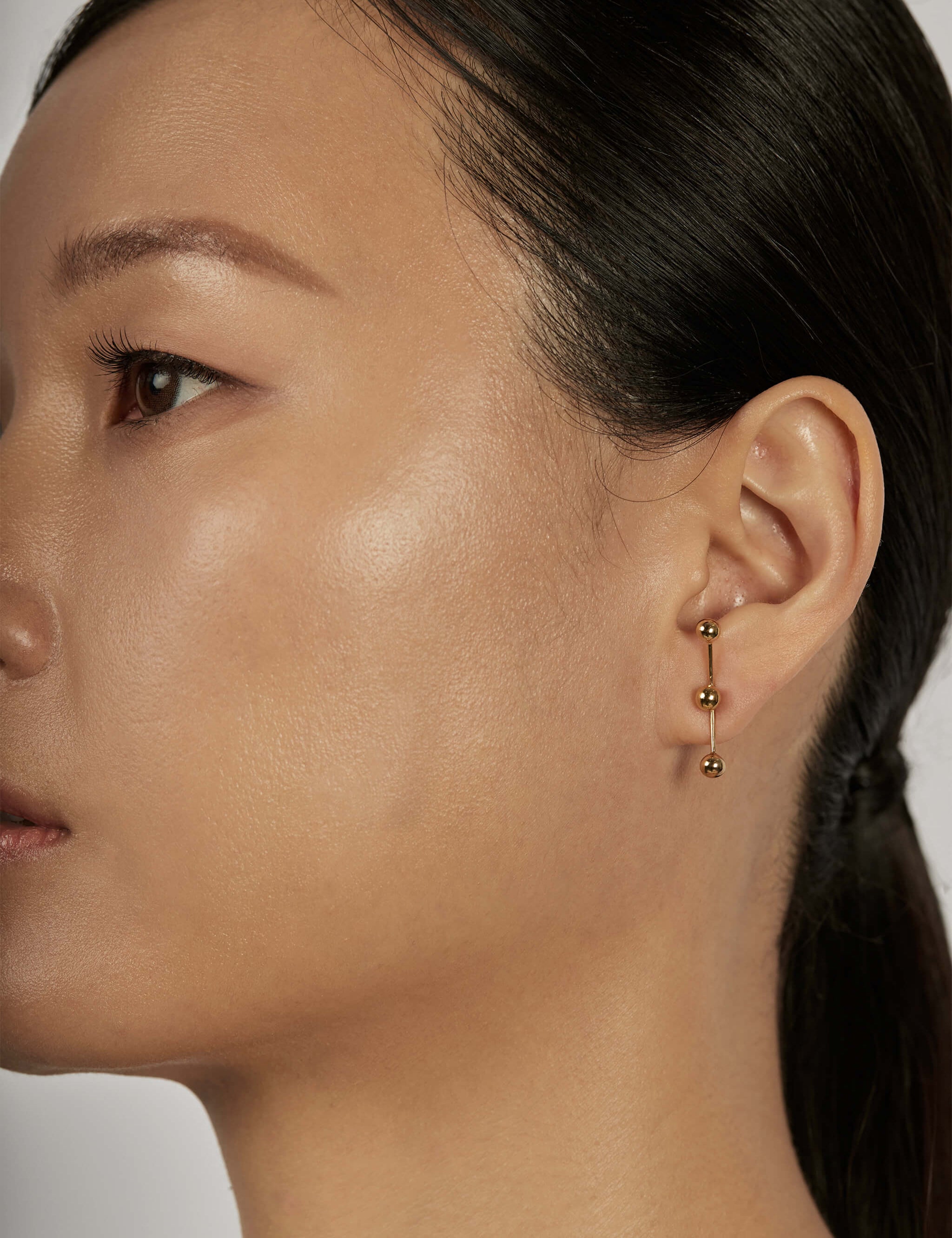 Sphere Drop Ear Jacket Earrings styled in a vertical look