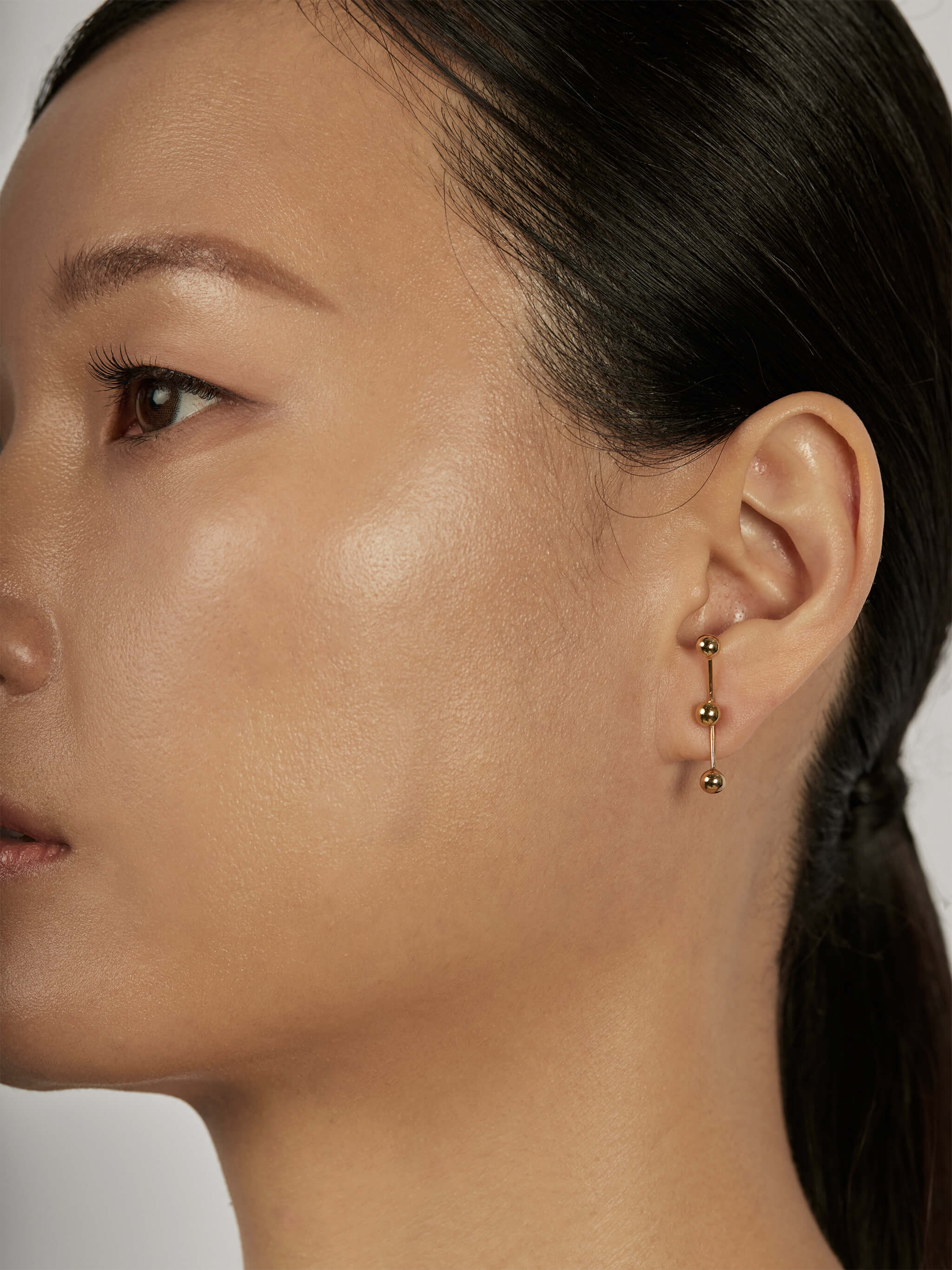 Sphere Drop Ear Jacket Earrings styled in a vertical look