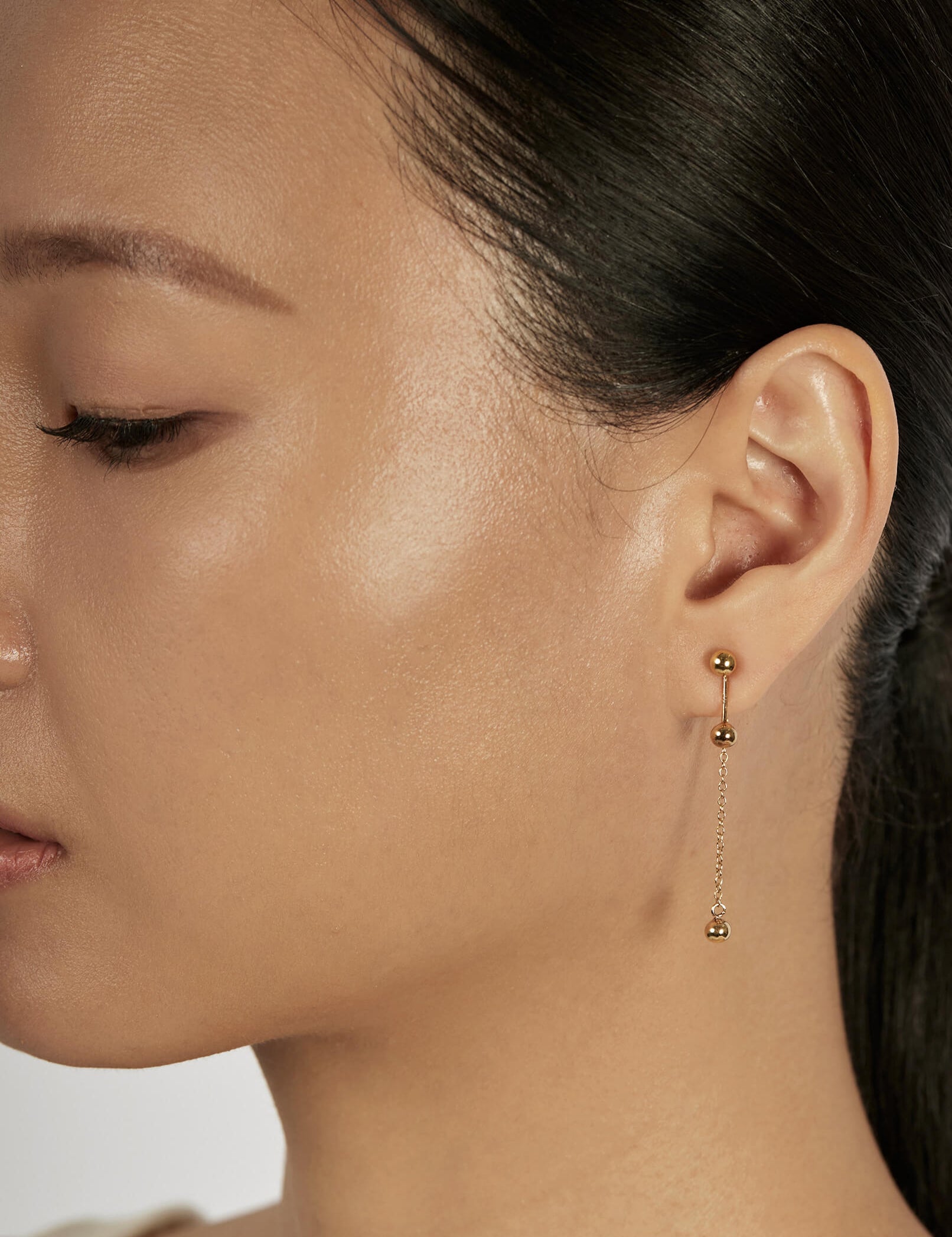 Sphere Stud Earrings styled in a layered ear stack