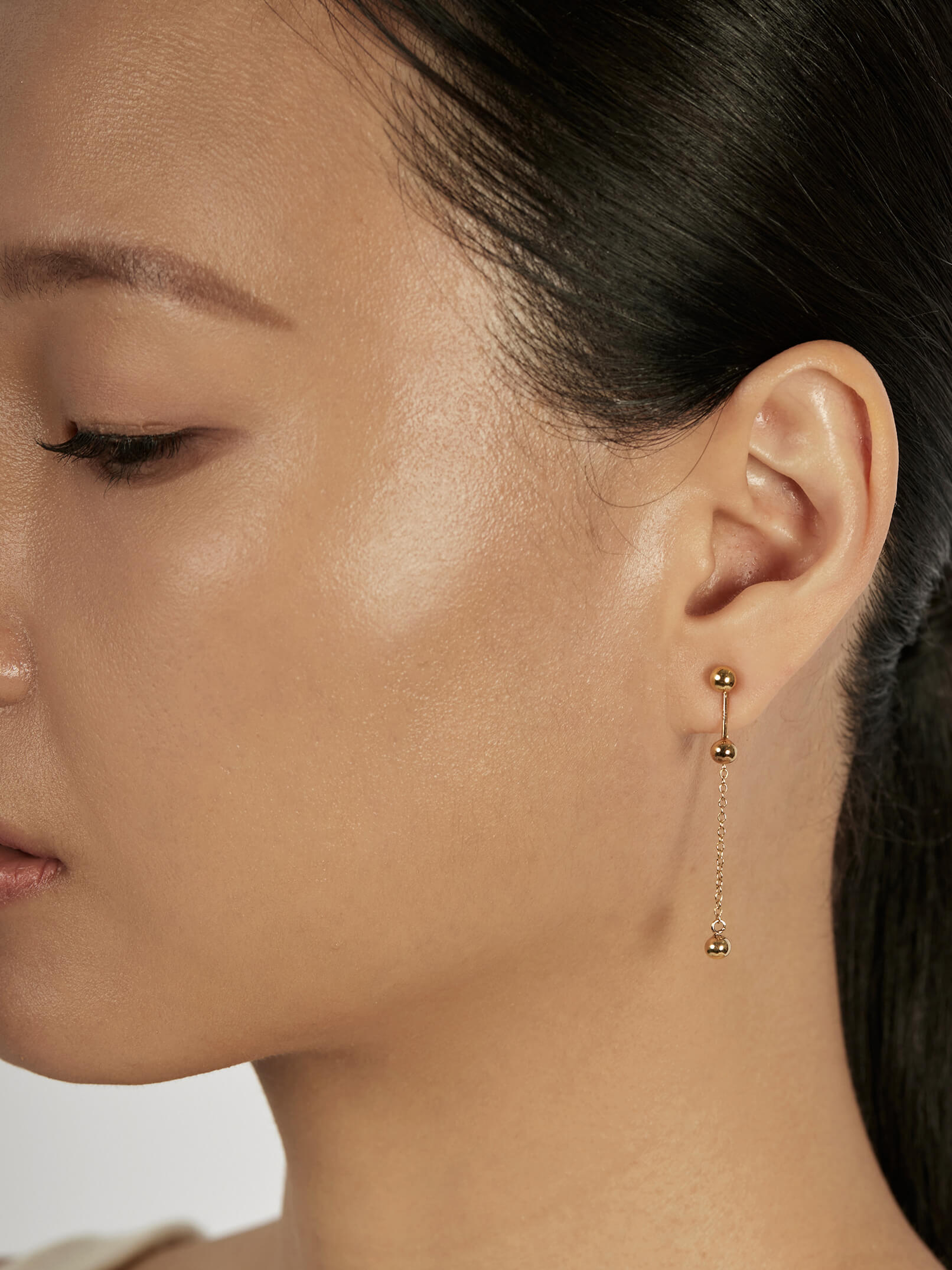 Sphere Stud Earrings styled in a layered ear stack