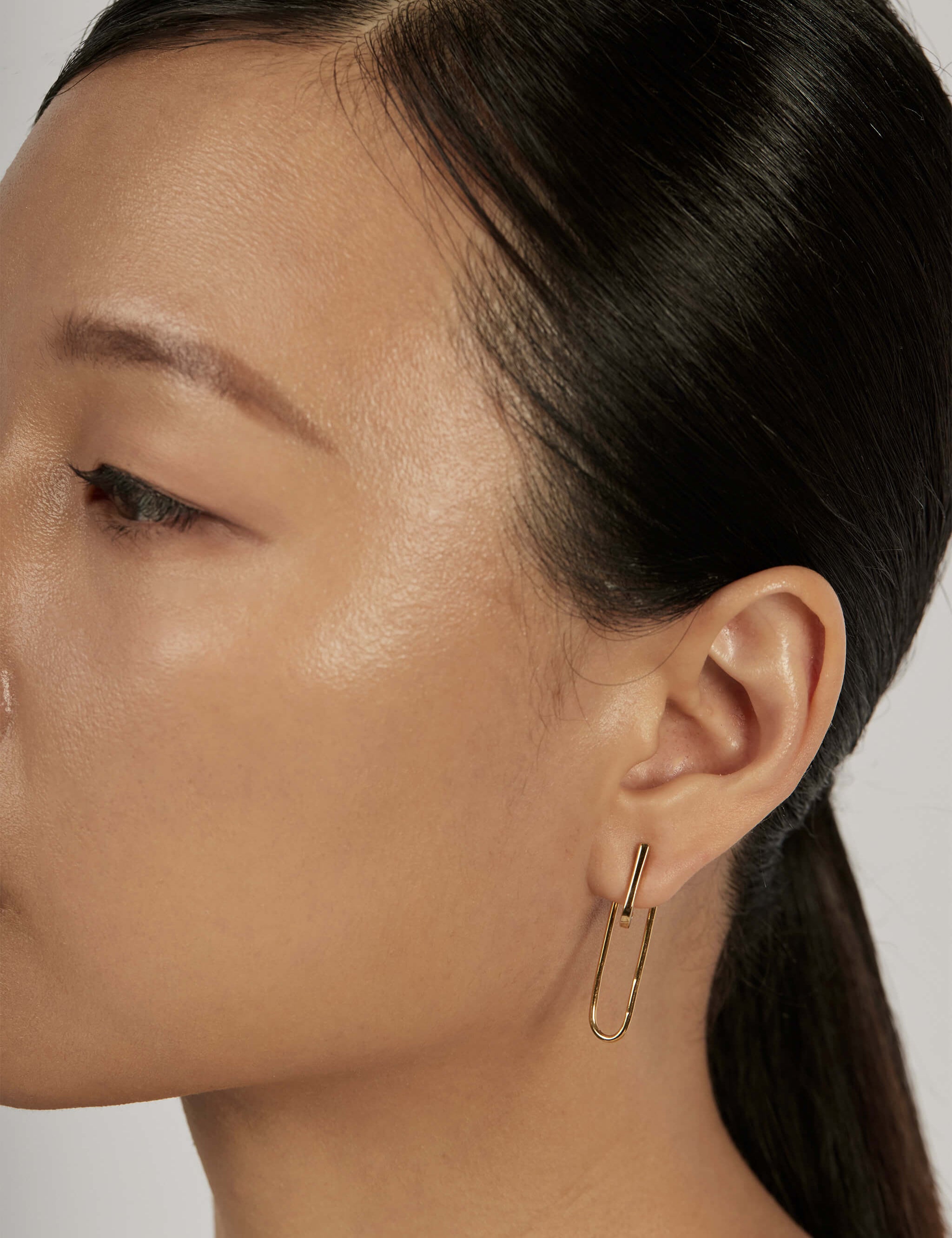 Suspend Bar Stud Earrings styled in a layered ear stack