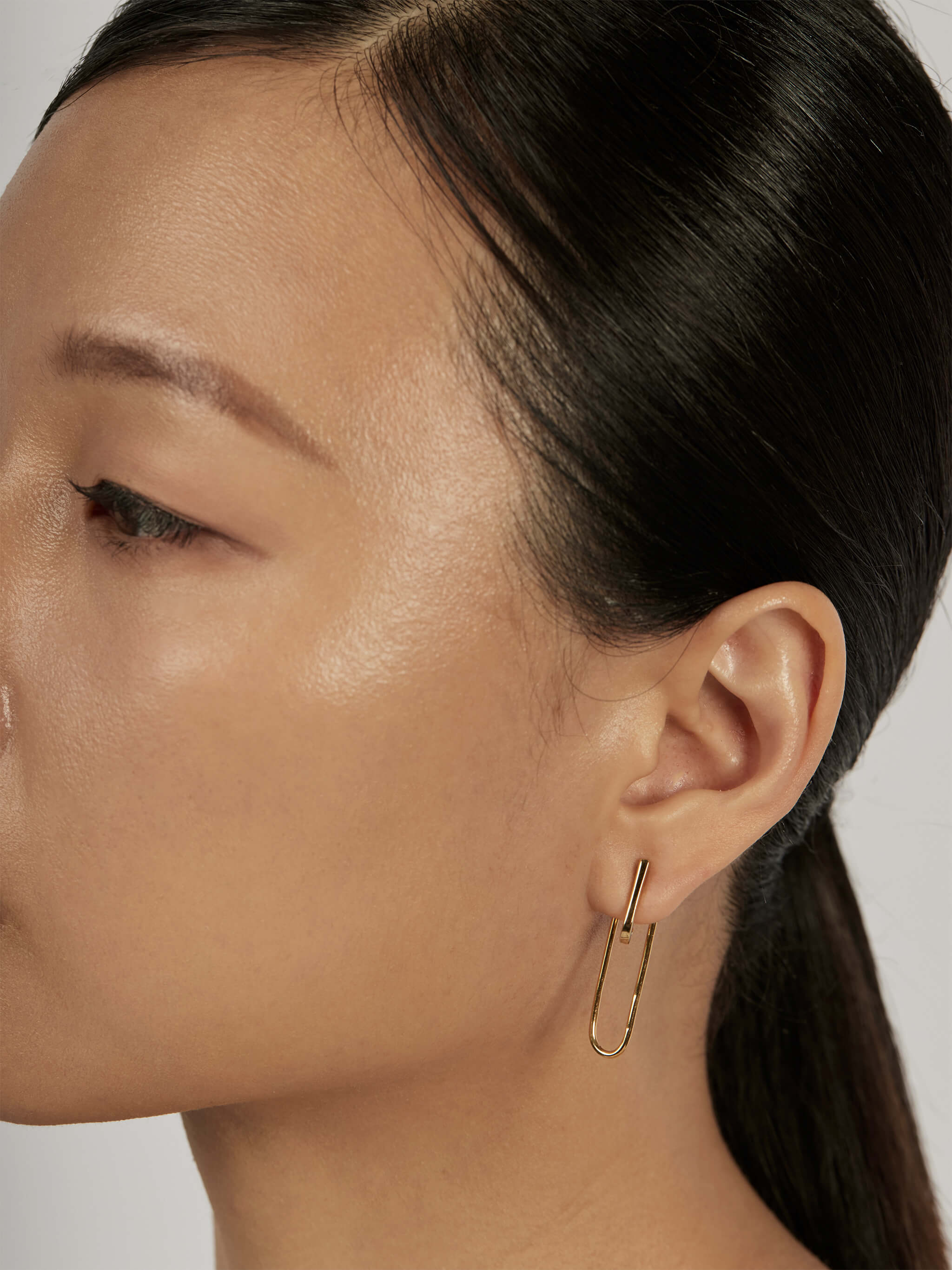 Suspend Bar Stud Earrings styled in a layered ear stack