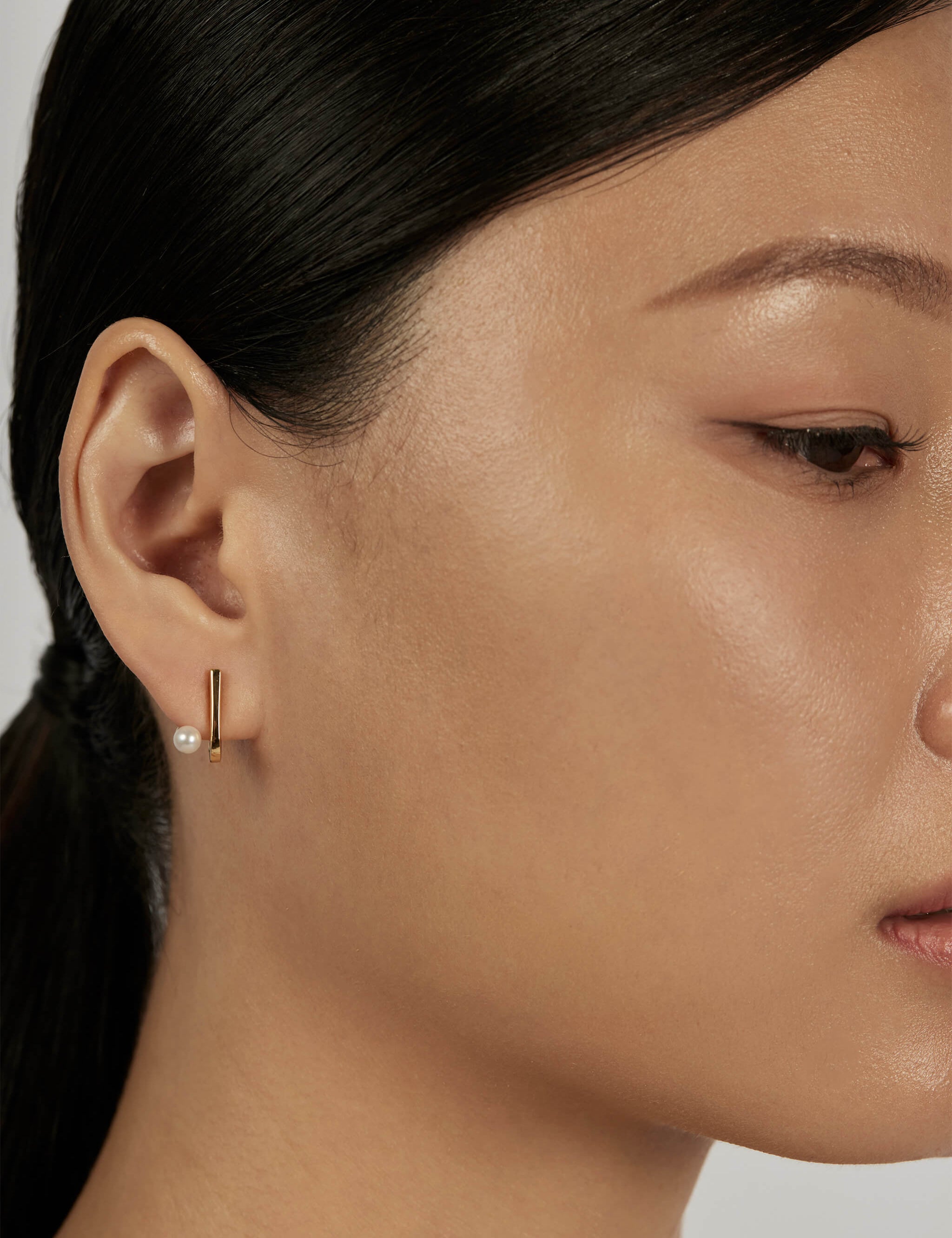 Suspend Bar Stud Earrings styled in a minimal ear stack