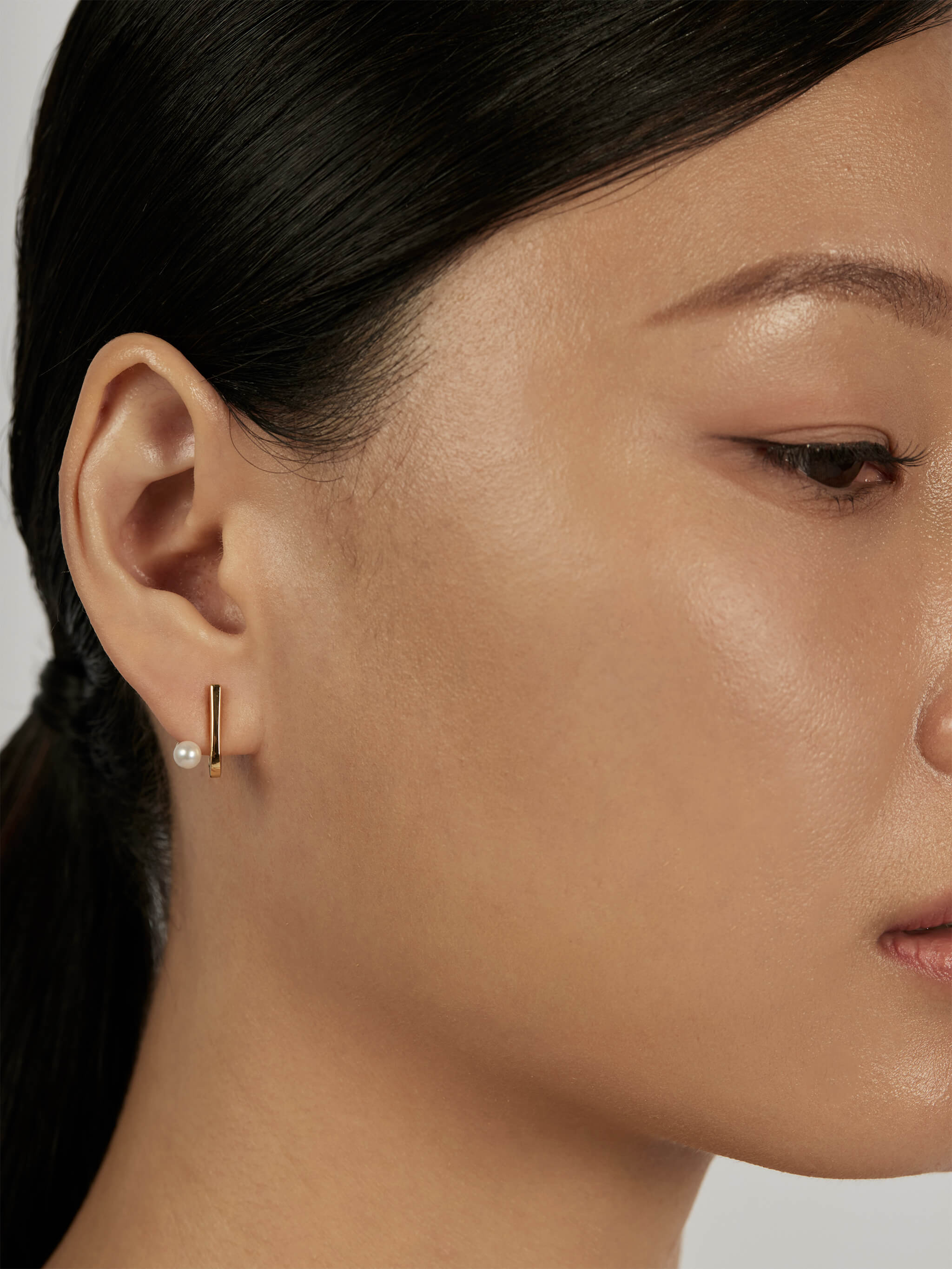 Suspend Bar Stud Earrings styled in a minimal ear stack